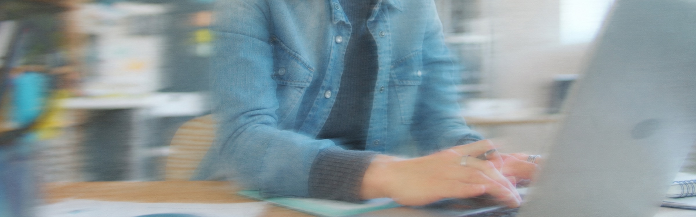 A person typing on a laptop at a desk