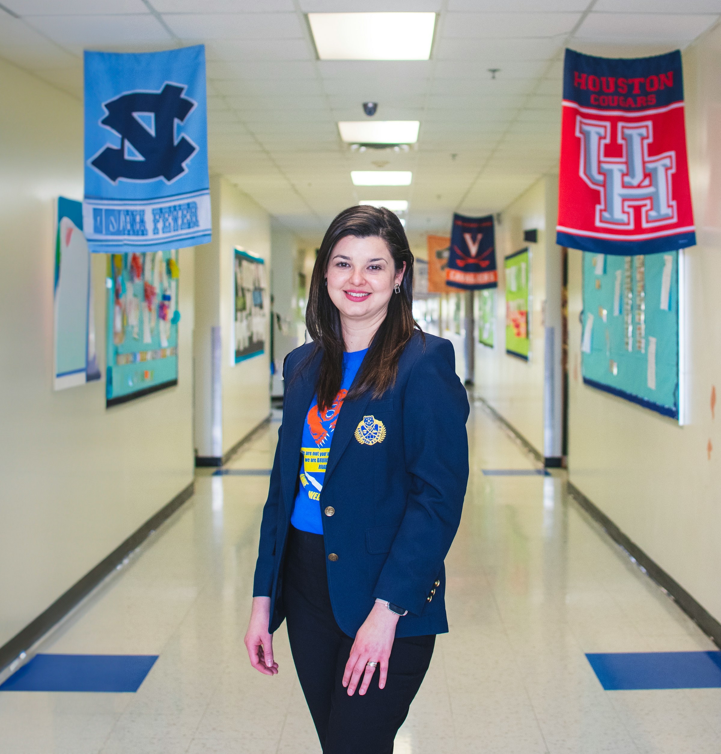 A staff member standing in a school hallway